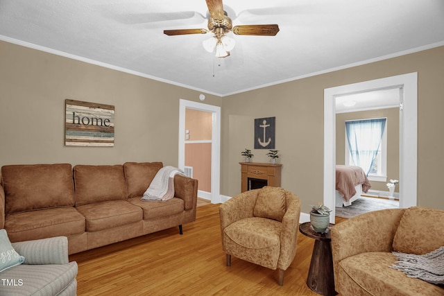 3315 Mebane Oaks Rd, Mebane, NC 27302 - living room featuring light wood finished floors, crown molding, ceiling fan, and baseboards