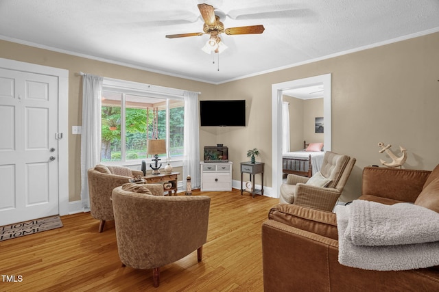 3315 Mebane Oaks Rd, Mebane, NC 27302 - living area featuring light wood-style flooring, ceiling fan, crown molding, and baseboards