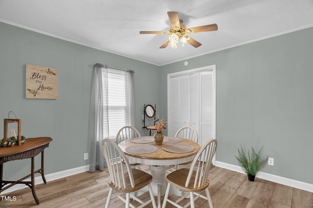 3315 Mebane Oaks Rd, Mebane, NC 27302 - dining area with light wood-type flooring, a ceiling fan, crown molding, and baseboards