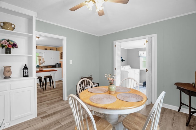3315 Mebane Oaks Rd, Mebane, NC 27302 - dining space with independent washer and dryer, a ceiling fan, light wood-style flooring, ornamental molding, and baseboards