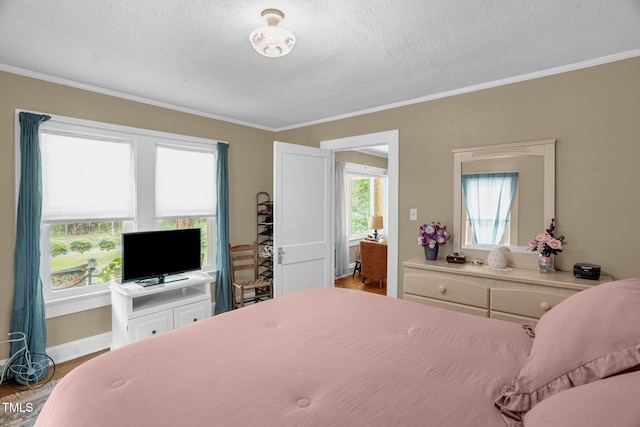 3315 Mebane Oaks Rd, Mebane, NC 27302 - bedroom featuring a textured ceiling, ornamental molding, wood finished floors, and baseboards