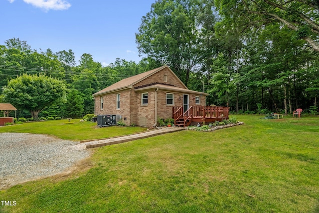 3315 Mebane Oaks Rd, Mebane, NC 27302 - rear view of property featuring brick siding, a wooden deck, a yard, and central air condition unit