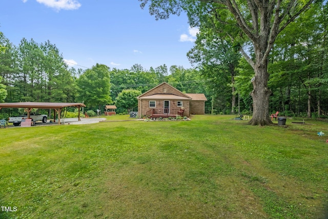 3315 Mebane Oaks Rd, Mebane, NC 27302 - view of grassy yard featuring a detached carport and a deck