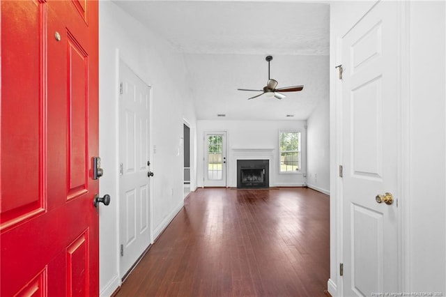 604 S Buckeye Dr, Raeford, NC 28376 - entrance foyer with a ceiling fan, dark wood finished floors, baseboards, a fireplace, and vaulted ceiling