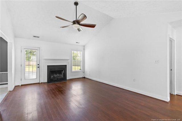 604 S Buckeye Dr, Raeford, NC 28376 - unfurnished living room with lofted ceiling, plenty of natural light, dark wood-type flooring, ceiling fan, and a fireplace with flush hearth
