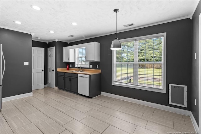 604 S Buckeye Dr, Raeford, NC 28376 - kitchen with a sink, dishwasher, baseboards, a textured ceiling, and crown molding