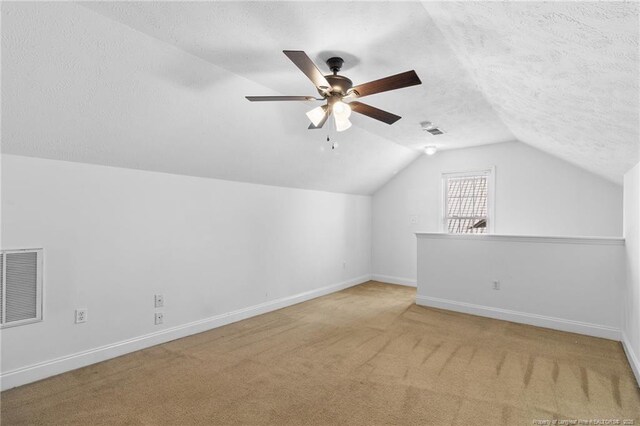 604 S Buckeye Dr, Raeford, NC 28376 - bonus room featuring vaulted ceiling, carpet, a ceiling fan, baseboards, and a textured ceiling