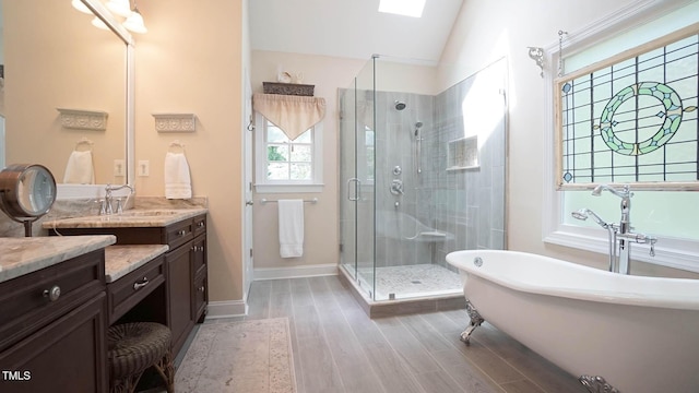 12037 Deer Run, Raleigh, NC 27614 - bathroom featuring a shower stall, wood finished floors, vanity, a freestanding bath, and lofted ceiling