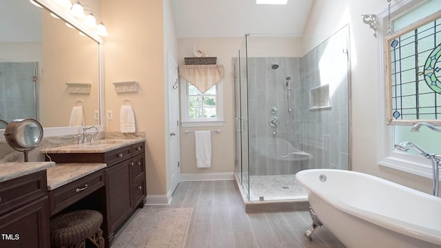 12037 Deer Run, Raleigh, NC 27614 - bathroom with a stall shower, a freestanding tub, vanity, wood finished floors, and vaulted ceiling