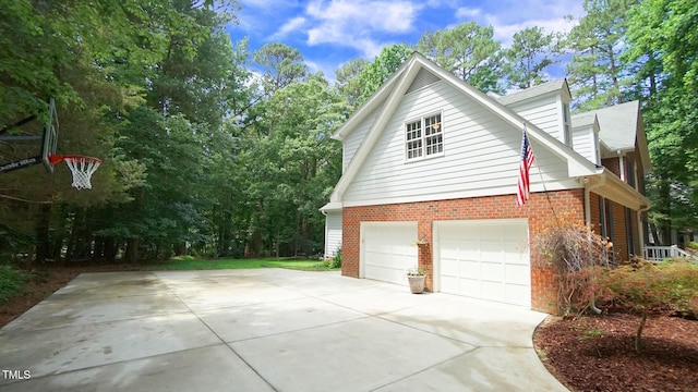 12037 Deer Run, Raleigh, NC 27614 - view of side of home with brick siding, a garage, and concrete driveway