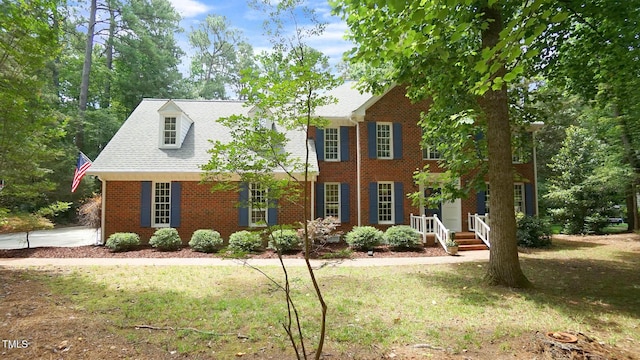 12037 Deer Run, Raleigh, NC 27614 - colonial-style house with brick siding, a front yard, and roof with shingles