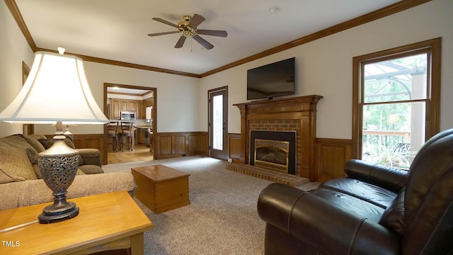 12037 Deer Run, Raleigh, NC 27614 - living area featuring a wainscoted wall, light colored carpet, a fireplace, crown molding, and a ceiling fan