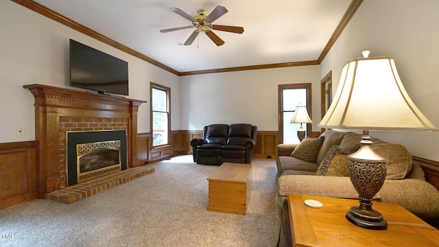 12037 Deer Run, Raleigh, NC 27614 - carpeted living area featuring wainscoting, crown molding, a brick fireplace, and a ceiling fan