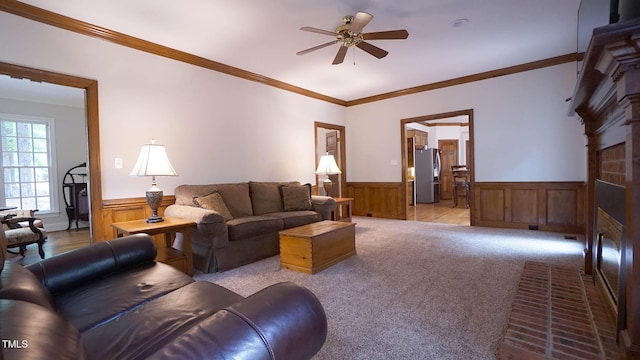 12037 Deer Run, Raleigh, NC 27614 - carpeted living room featuring wainscoting, ceiling fan, crown molding, a brick fireplace, and wooden walls