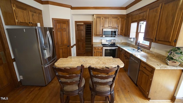 12037 Deer Run, Raleigh, NC 27614 - kitchen featuring stainless steel appliances, ornamental molding, light wood finished floors, light stone counters, and a kitchen island