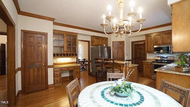 12037 Deer Run, Raleigh, NC 27614 - dining area featuring wood finished floors, a chandelier, and ornamental molding