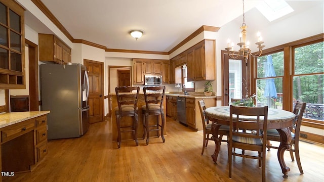 12037 Deer Run, Raleigh, NC 27614 - dining area with a chandelier, a skylight, plenty of natural light, and crown molding