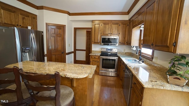 12037 Deer Run, Raleigh, NC 27614 - kitchen with stainless steel appliances, dark wood-style floors, light stone countertops, ornamental molding, and brown cabinets