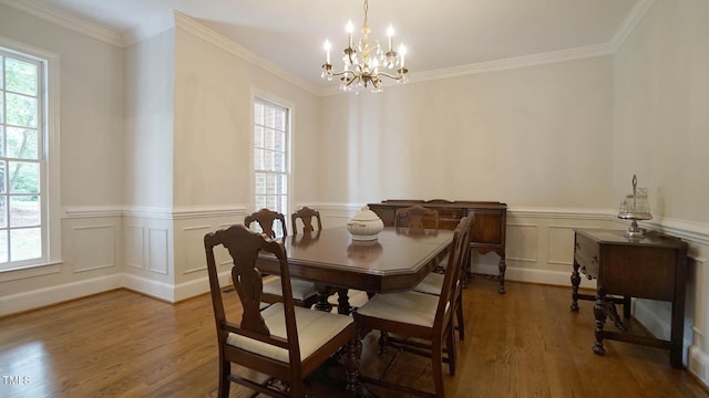 12037 Deer Run, Raleigh, NC 27614 - dining area with a chandelier, wood finished floors, wainscoting, ornamental molding, and a decorative wall