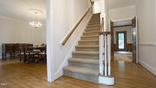 12037 Deer Run, Raleigh, NC 27614 - stairway featuring crown molding, wood finished floors, and a chandelier
