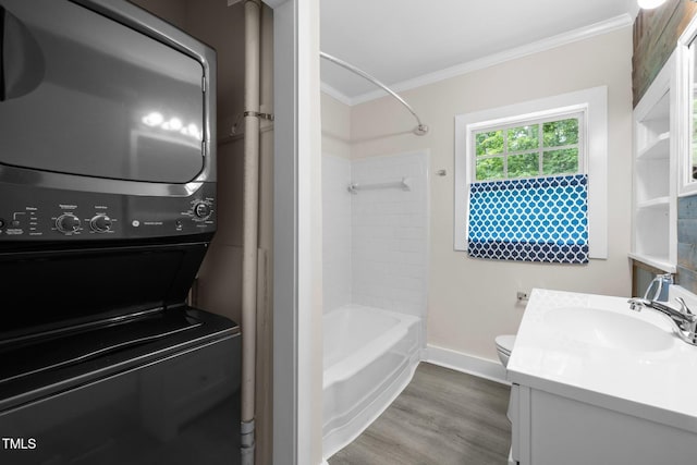105 Hanna St, Carrboro, NC 27510 - bathroom with stacked washer and clothes dryer, ornamental molding, vanity, wood finished floors, and shower / bath combination