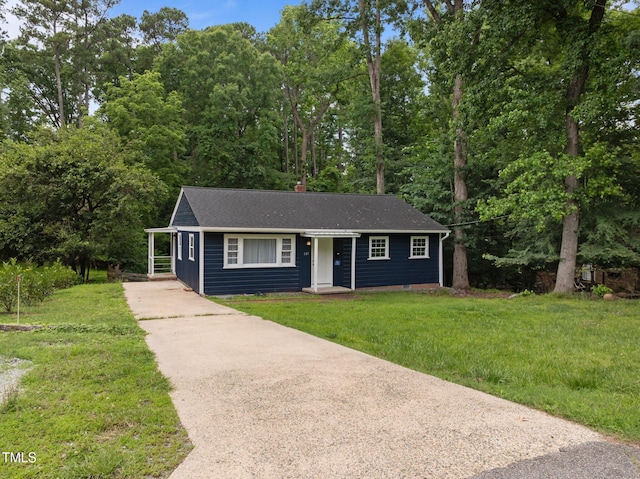 105 Hanna St, Carrboro, NC 27510 - ranch-style house with concrete driveway, a front lawn, and a chimney