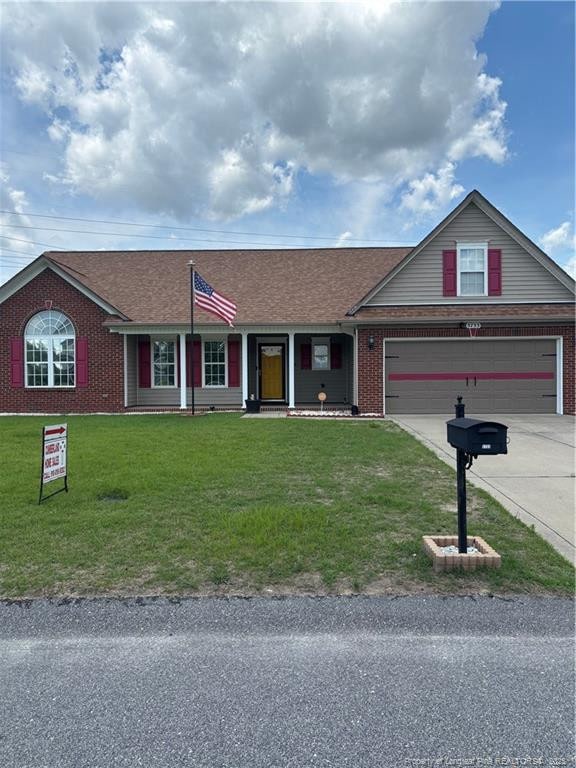 5733 Azure Dr, Hope Mills, NC 28348 - ranch-style home with brick siding, concrete driveway, a front yard, a garage, and a shingled roof