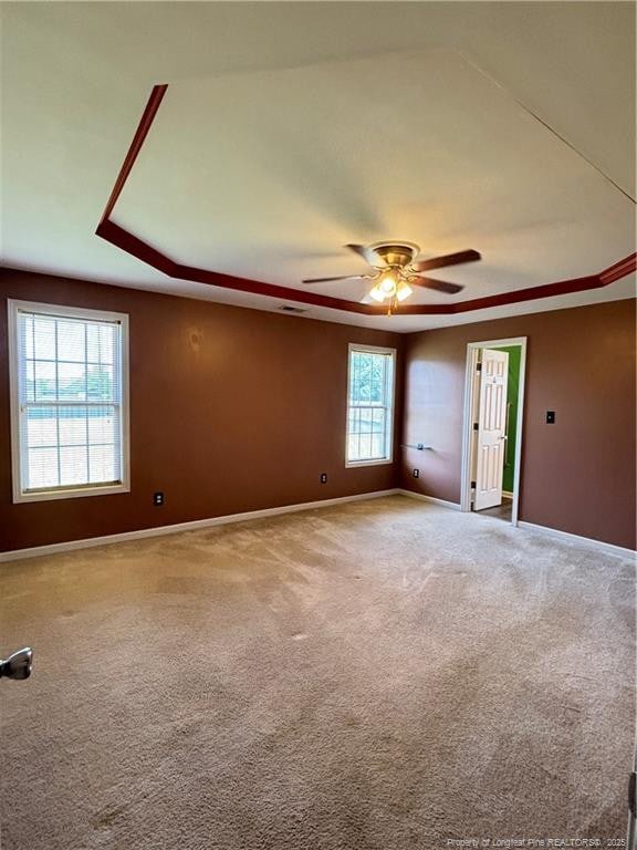 5733 Azure Dr, Hope Mills, NC 28348 - carpeted spare room with baseboards, ceiling fan, and a raised ceiling