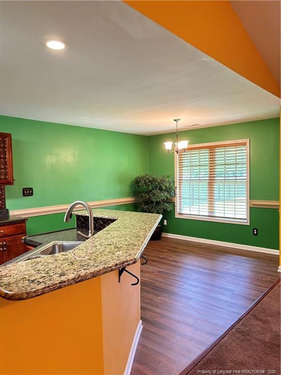 5733 Azure Dr, Hope Mills, NC 28348 - kitchen featuring a sink, dark wood-style flooring, a chandelier, baseboards, and recessed lighting