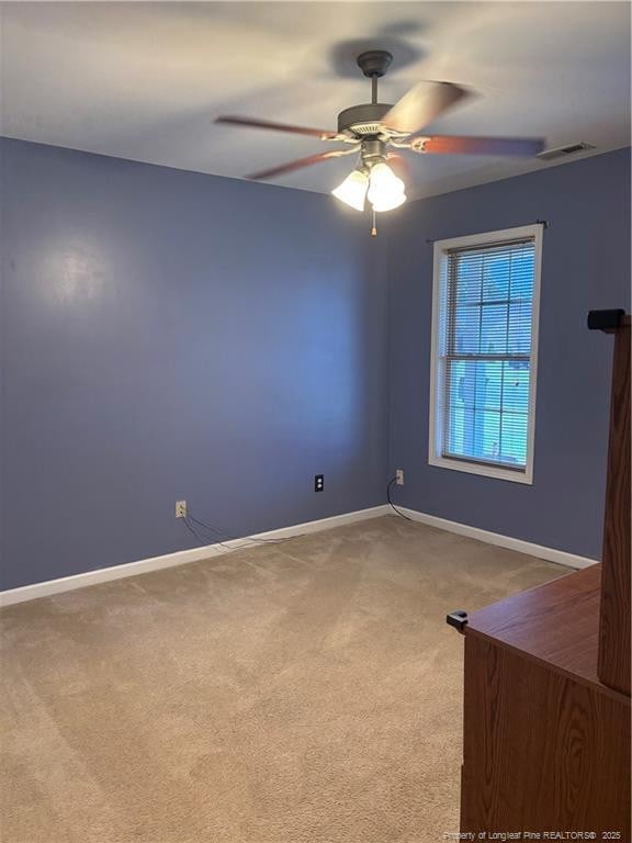 5733 Azure Dr, Hope Mills, NC 28348 - empty room featuring carpet flooring, baseboards, and a ceiling fan