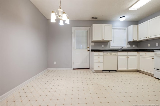 405 Cityview Ln, Fayetteville, NC 28301 - kitchen with dishwasher, light floors, white cabinetry, and dark countertops