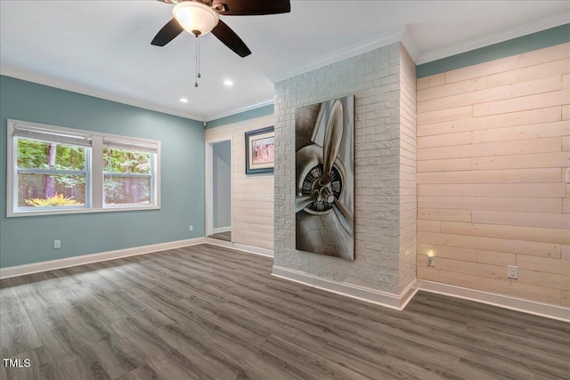 224 Oakcrest Dr, Wake Forest, NC 27587 - unfurnished living room featuring crown molding, ceiling fan, dark wood finished floors, baseboards, and wooden walls
