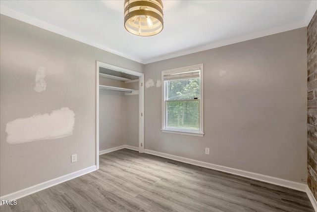 224 Oakcrest Dr, Wake Forest, NC 27587 - unfurnished bedroom featuring crown molding, wood finished floors, baseboards, and a closet
