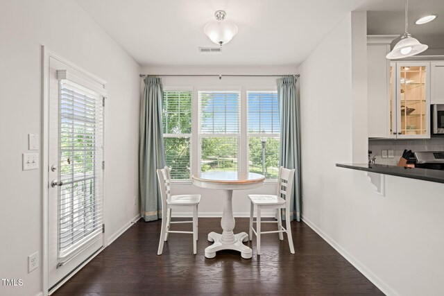 9141 Falkwood Rd, Raleigh, NC 27617 - dining space featuring healthy amount of natural light and dark wood-type flooring
