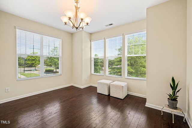 9141 Falkwood Rd, Raleigh, NC 27617 - spare room featuring a chandelier, plenty of natural light, and dark wood-type flooring