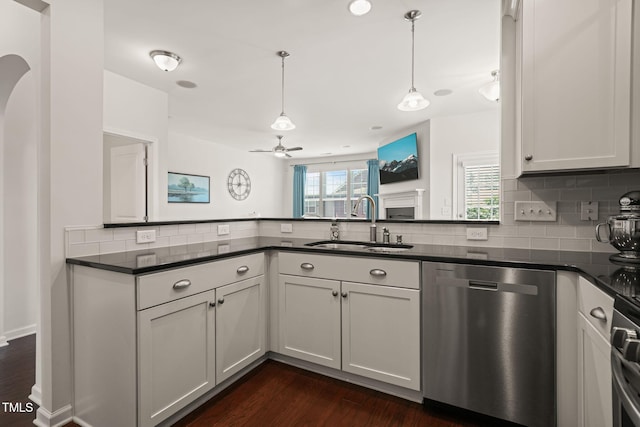 9141 Falkwood Rd, Raleigh, NC 27617 - kitchen featuring dishwasher, dark countertops, dark wood-style flooring, and tasteful backsplash