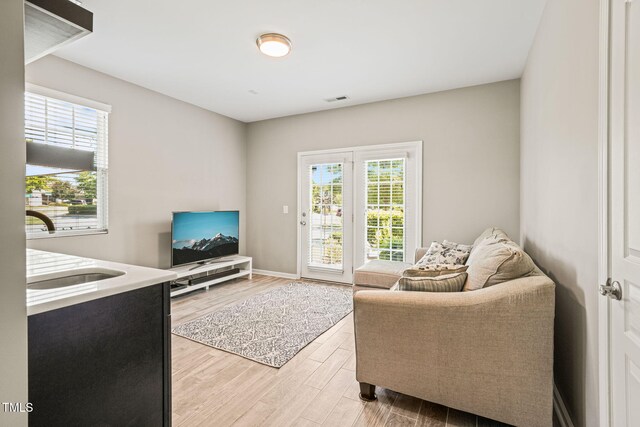 9141 Falkwood Rd, Raleigh, NC 27617 - living area featuring light wood-type flooring and baseboards