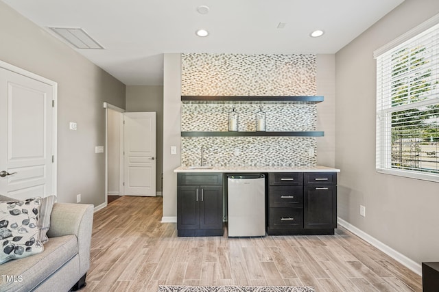 9141 Falkwood Rd, Raleigh, NC 27617 - indoor bar featuring light wood-style flooring, recessed lighting, and refrigerator