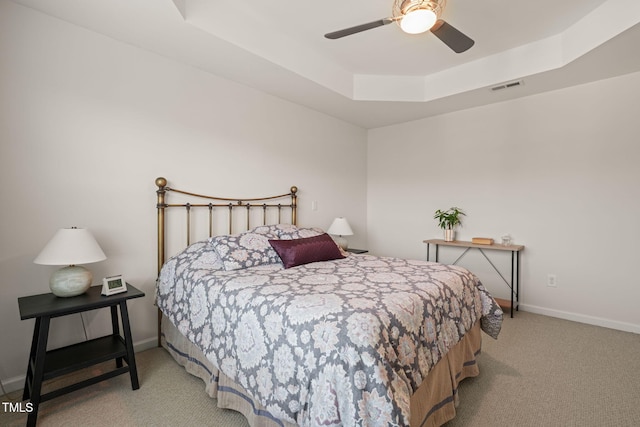 9141 Falkwood Rd, Raleigh, NC 27617 - bedroom with carpet, a tray ceiling, and ceiling fan