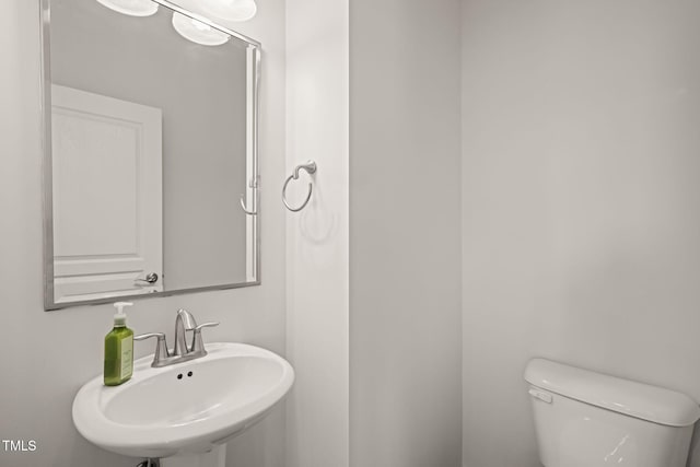 9141 Falkwood Rd, Raleigh, NC 27617 - half bathroom featuring a sink and toilet