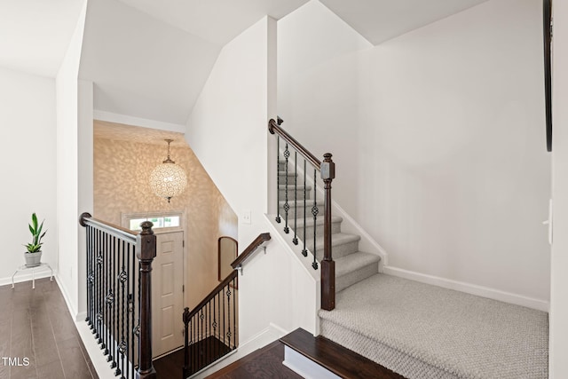 9141 Falkwood Rd, Raleigh, NC 27617 - staircase featuring wood finished floors and vaulted ceiling