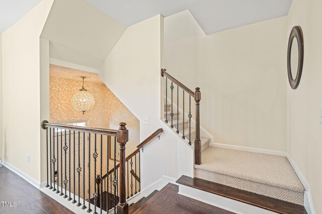 9141 Falkwood Rd, Raleigh, NC 27617 - stairway with a chandelier and wood finished floors