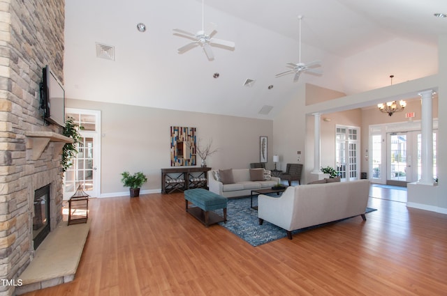 9141 Falkwood Rd, Raleigh, NC 27617 - living area featuring high vaulted ceiling, a stone fireplace, wood finished floors, ceiling fan, and ornate columns