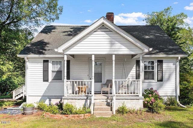 506 Currin St, Durham, NC 27703 - view of front of house with a chimney, a porch, and a shingled roof