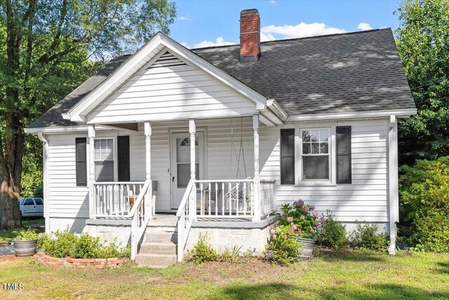 506 Currin St, Durham, NC 27703 - view of front of home featuring covered porch, a chimney, and roof with shingles