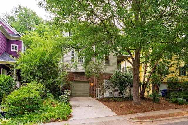 244 Sweet Bay Pl, Carrboro, NC 27510 - obstructed view of property with stairs, brick siding, driveway, and a garage