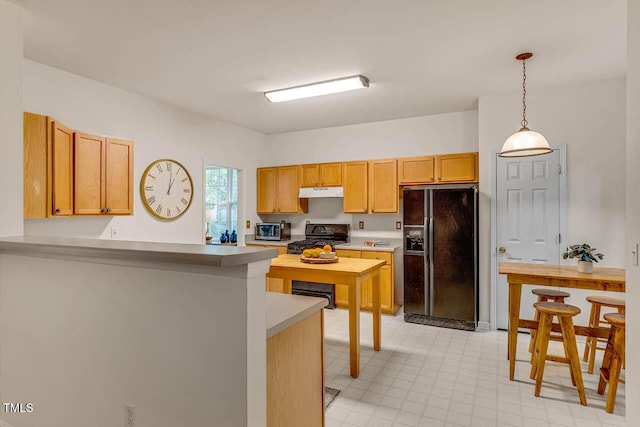 244 Sweet Bay Pl, Carrboro, NC 27510 - kitchen with black fridge with ice dispenser, gas range oven, under cabinet range hood, a peninsula, and pendant lighting