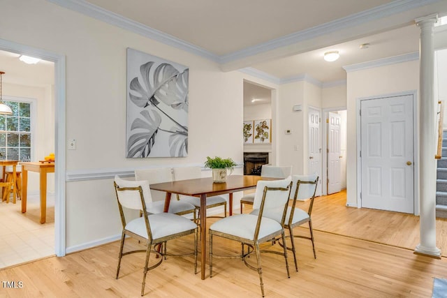 244 Sweet Bay Pl, Carrboro, NC 27510 - dining area with stairway, light wood-style floors, crown molding, and a fireplace