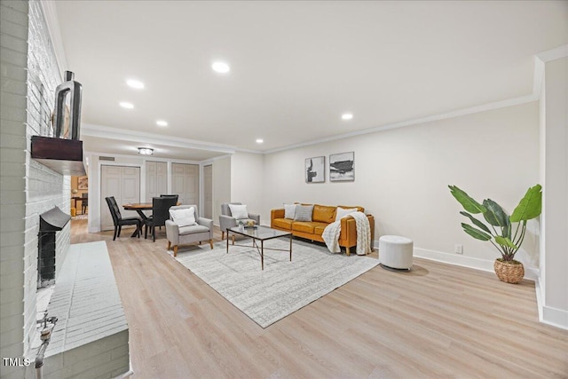 800 Camden Ave, Durham, NC 27701 - living area with a fireplace, wood finished floors, baseboards, crown molding, and recessed lighting