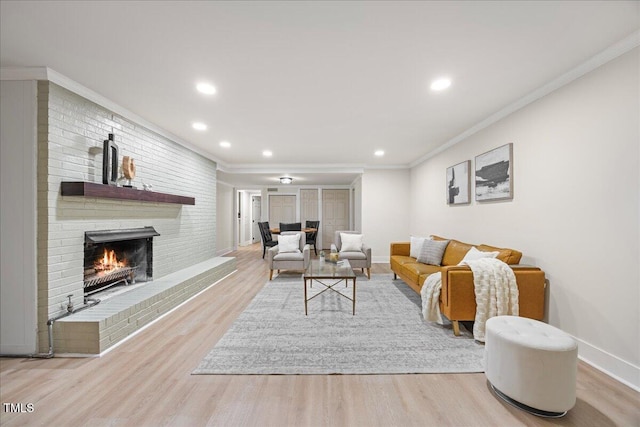 800 Camden Ave, Durham, NC 27701 - living room with wood finished floors, a brick fireplace, recessed lighting, crown molding, and baseboards
